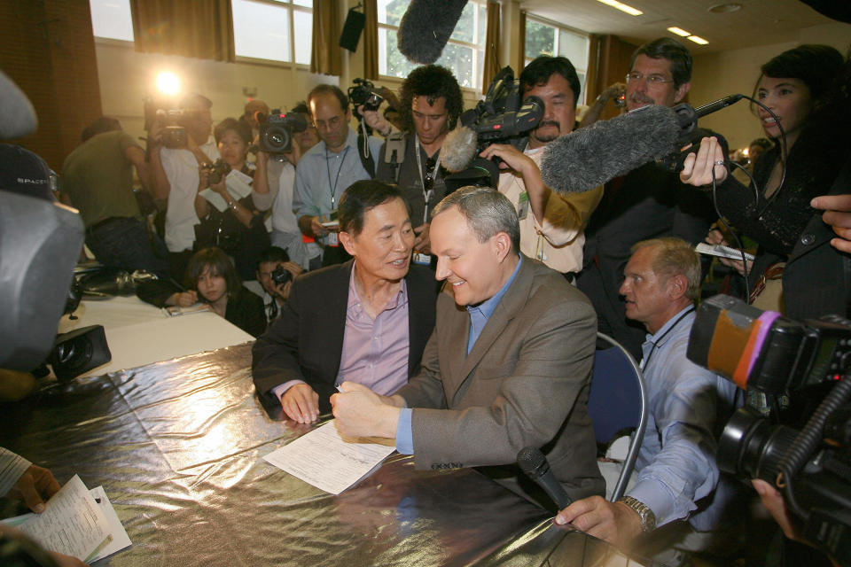 George Takei and his partner Brad (Altman) Takei sign marriage documents on&nbsp;June 17, 2008, in West Hollywood, California.