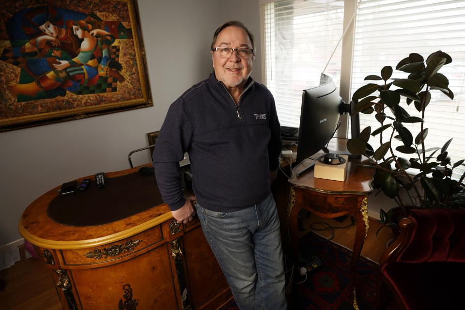 Kenneth Eaton, a day trader, poses in his home office in Franklin, Tenn., Jan. 14, 2021. Eaton, a 63-year-old Nashville businessman, was proud to serve as a Trump delegate at the Republican National Convention in 2016. (AP Photo/Mark Humphrey)