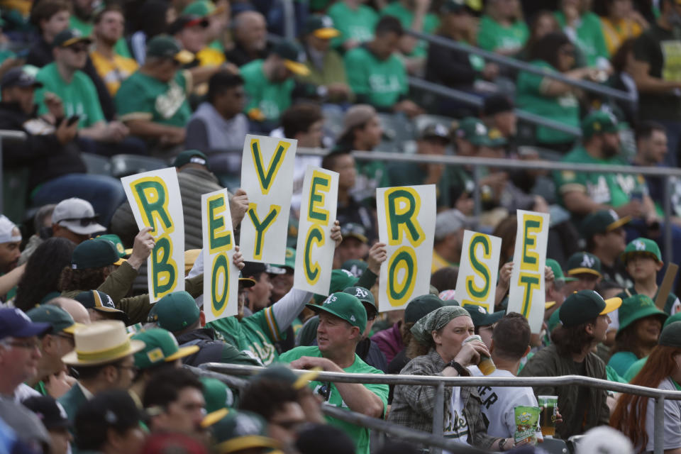 FILE - Fans hold signs inside of the Oakland Coliseum to protest the Oakland Athletics' planned move to Las Vegas during a baseball game between the Athletics and the Tampa Bay Rays in Oakland, Calif., Tuesday, June 13, 2023. (AP Photo/Jed Jacobsohn, File)