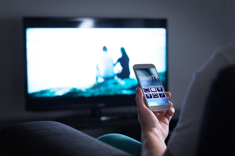 <span class="caption">Researchers still don’t know the root of what causes decreased attention and memory in heavy media multitaskers.</span> <span class="attribution"><a class="link " href="https://www.shutterstock.com/image-photo/man-watching-television-using-smart-tv-788108020?src=rSMd1exHNn0OYPd5wCppLg-1-0" rel="nofollow noopener" target="_blank" data-ylk="slk:Tero Vesalainen/ Shutterstock;elm:context_link;itc:0;sec:content-canvas">Tero Vesalainen/ Shutterstock</a></span>