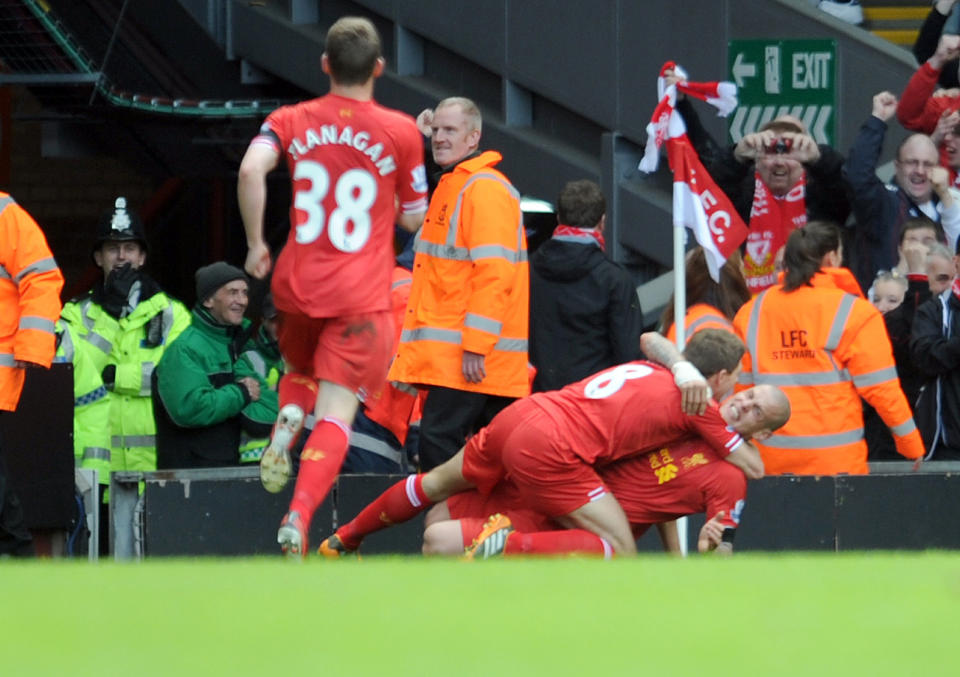 Liverpool's Martin Skrtel right, celebrates with team-mate Steven Gerrard after he scores the second goal of the game for his side during their English Premier League soccer match against Manchester City at Anfield in Liverpool, England, Sunday April. 13, 2014. (AP Photo/Clint Hughes)