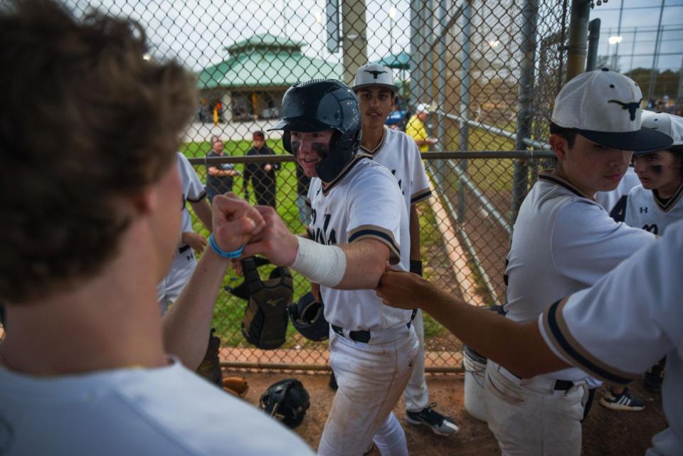 West Boca third baseman James Evans (2) hi-fives teammates in the dugout after scoring during the Class 7A District 12 semifinal between West Boca and Boca Raton at the Santaluces Athletic Complex a in Lake Worth, FL., on Tuesday, May 3, 2022. Final score, West Boca, 5, Boca Raton, 4.