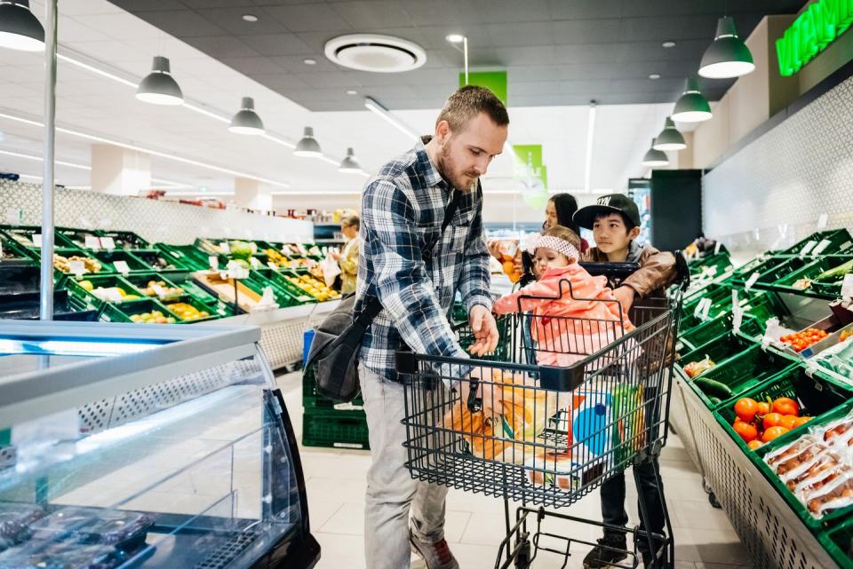 a family buying groceries together at their local supermarket