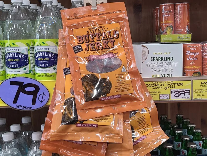 packages of buffalo jerky hanging next to the shelves at trader joes