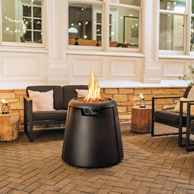 A tiki brand propane fire pit on a patio