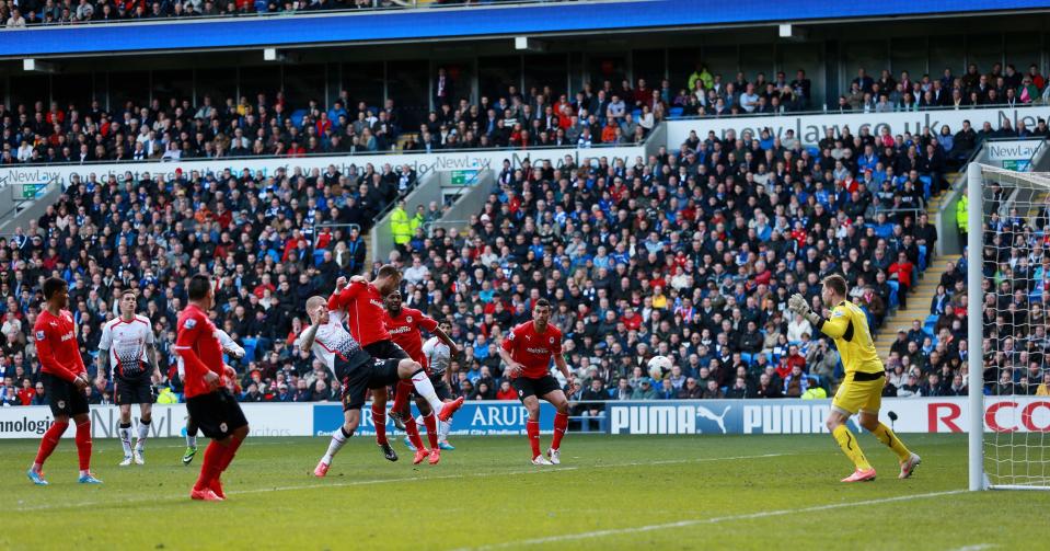 Liverpool's Martin Skrtel, center right, scores his side's second goal during their English Premier League soccer match against Cardiff City at Cardiff City Stadium, Cardiff, Wales, Saturday, March 22, 2014. (AP Photo/David Davies, PA Wire) UNITED KINGDOM OUT - NO SALES - NO ARCHIVES
