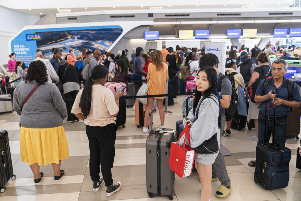 Travelers line up at the Southwest Airline ticket counter in the departures area of Terminal B at LaGuardia Airport, Tuesday, June 27, 2023, in New York. Travelers waited out widespread delays at U.S. airports on Tuesday, an ominous sign heading into the long July 4 holiday weekend, which is shaping up as the biggest test yet for airlines that are struggling to keep up with surging numbers of passengers.(AP Photo/Mary Altaffer)