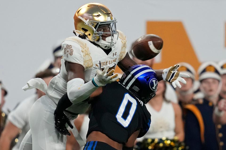 Notre Dame wide receiver Jayden Thomas (83) catches a pass over BYU defensive back Jakob Robinson (0) before running in for a touchdown.