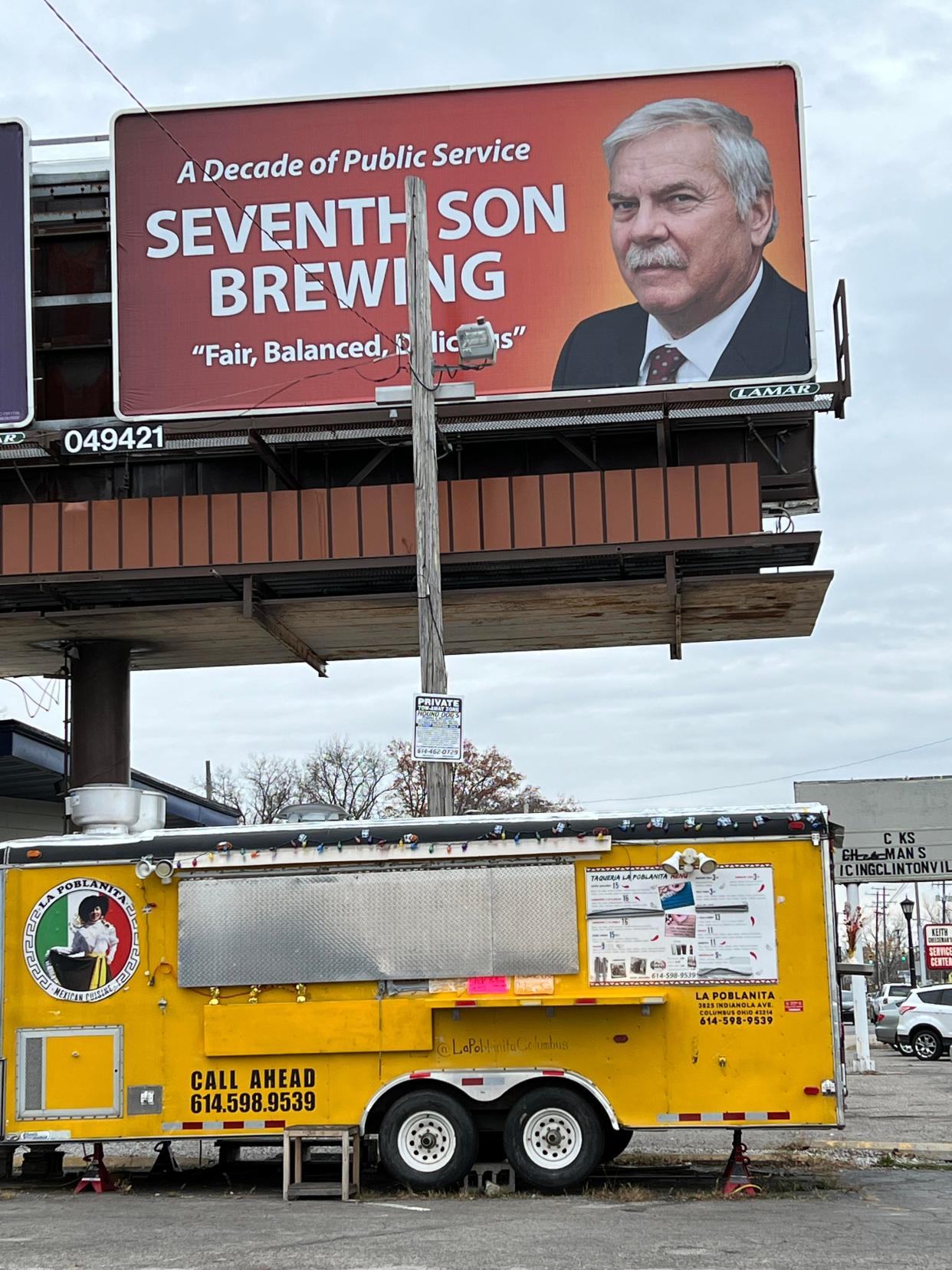 A billboard for Seventh Son brewery on Indianola Avenue mimics the colors, typography and wording of a political ad featuring Judge Michael Holbrook. The judge says he has no idea why the brewery does this promotion.