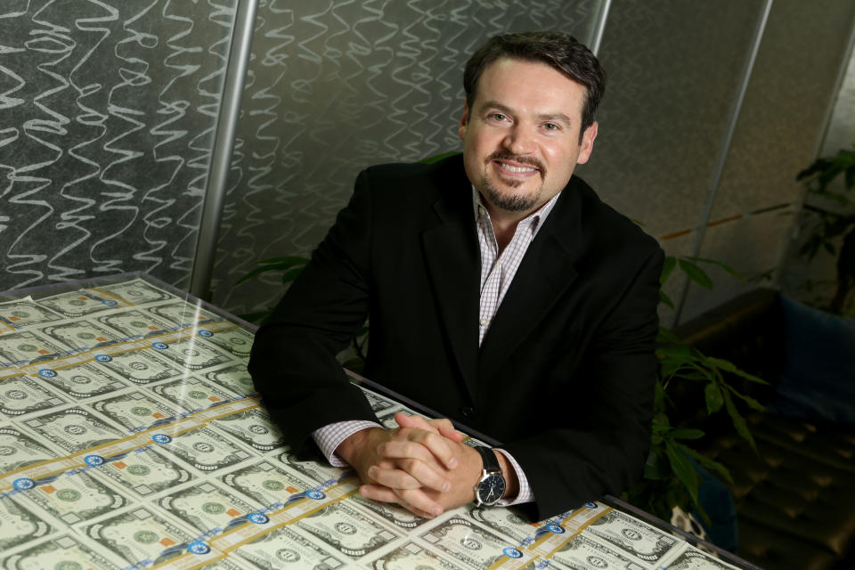 Coupa CEO Rob Bernshteyn poses for a photograph, with stacks of oversized, mock $1000 bills used to help clients visualize the amount of money they can save, at their headquarters in San Mateo, Calif., on Friday, Aug. 18, 2017. The software company provides a cloud based management platform for business spending. (Anda Chu/Bay Area News Group) (Photo by MediaNews Group/Bay Area News via Getty Images)