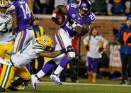 Minnesota Vikings running back Adrian Peterson (28) rushes for a 6 yard touchdown despite the efforts of Green Bay Packers safety Ha Ha Clinton-Dix (21) in the third quarter at TCF Bank Stadium. The Packers win 30-13. Mandatory Credit: Bruce Kluckhohn-USA TODAY Sports