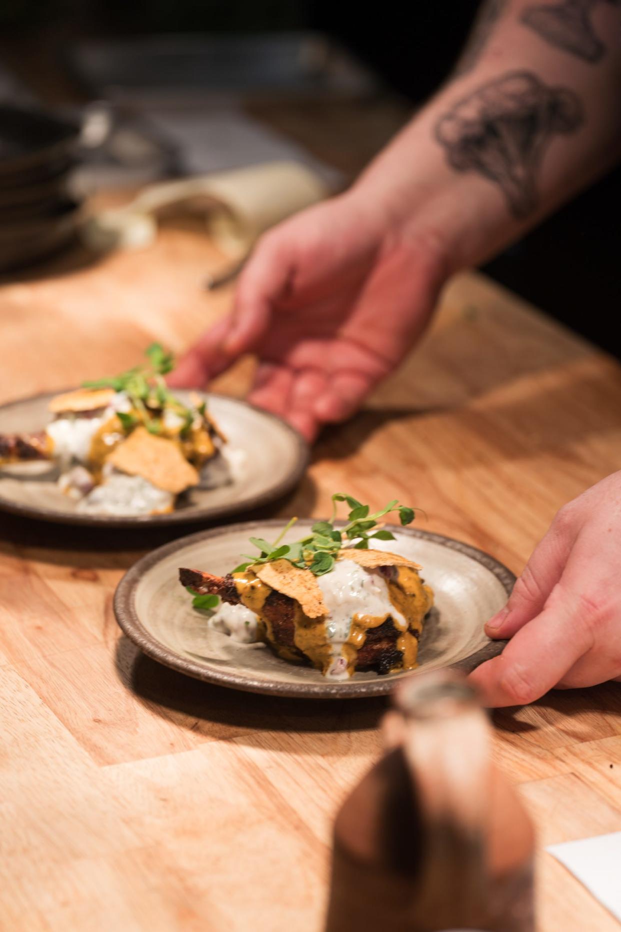 Eamonn McParland, owner and chef at Roselily, prepares a duck confit for a chef's table experience at the South Bend restaurant.