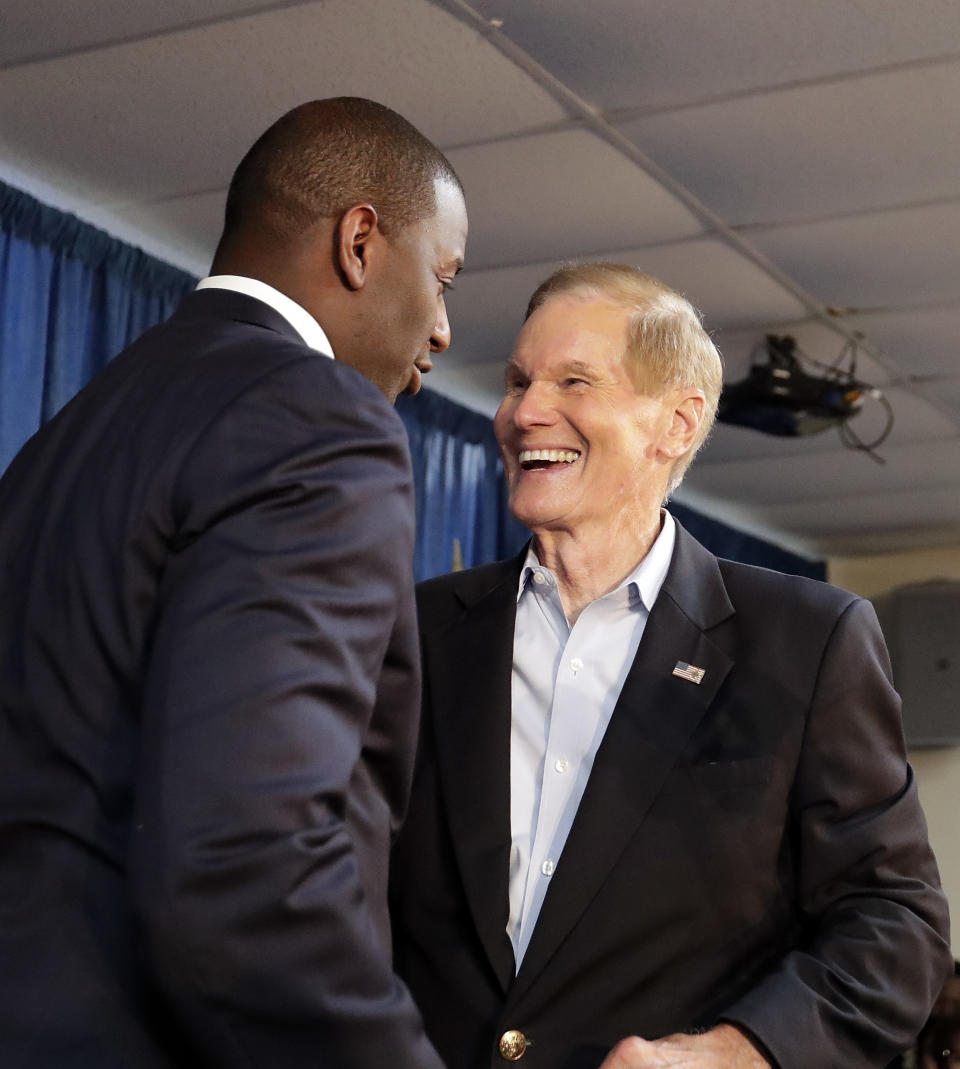 Florida Democratic gubernatorial candidate Andrew Gillum, left, greets Sen. Bill Nelson, D-Fla. before speaking to supporters at a Democratic Party rally Friday, Aug. 31, 2018, in Orlando, Fla. (AP Photo/John Raoux)