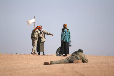 FILE PHOTO: Men that fled areas of clashes surrender to Syrian Democratic Forces (SDF) fighters north of Raqqa city, Syria March 8, 2017. REUTERS/Rodi Said/File Photo