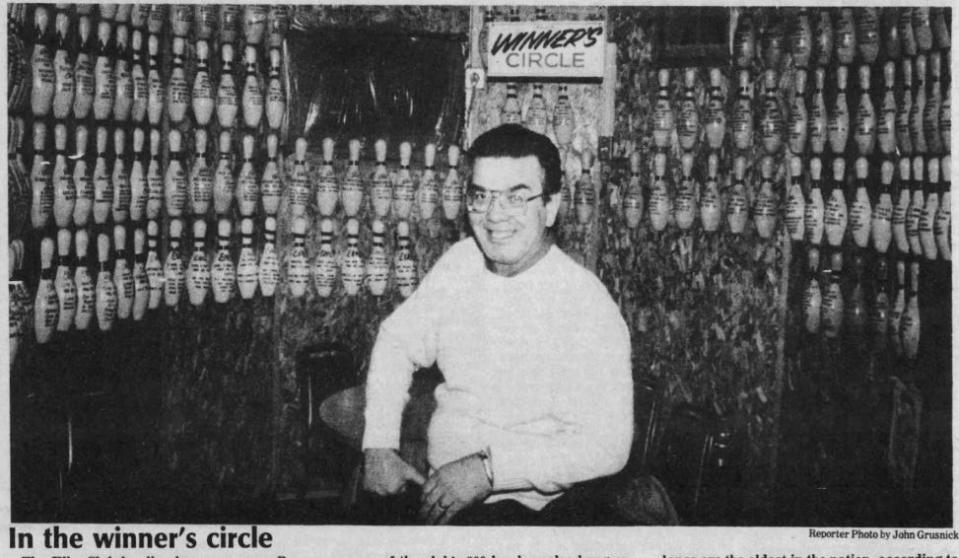 Then-lanes manager Ray Burgess shows off the Elks Club's bowling "winner's circle" in this 1989 file photo.