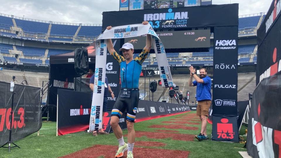 Penn State alumnus Matthew Guenter celebrates his first-place overall finish in the Ironman 70.3 Pennsylvania Happy Valley triathlon Sunday at Beaver Stadium.