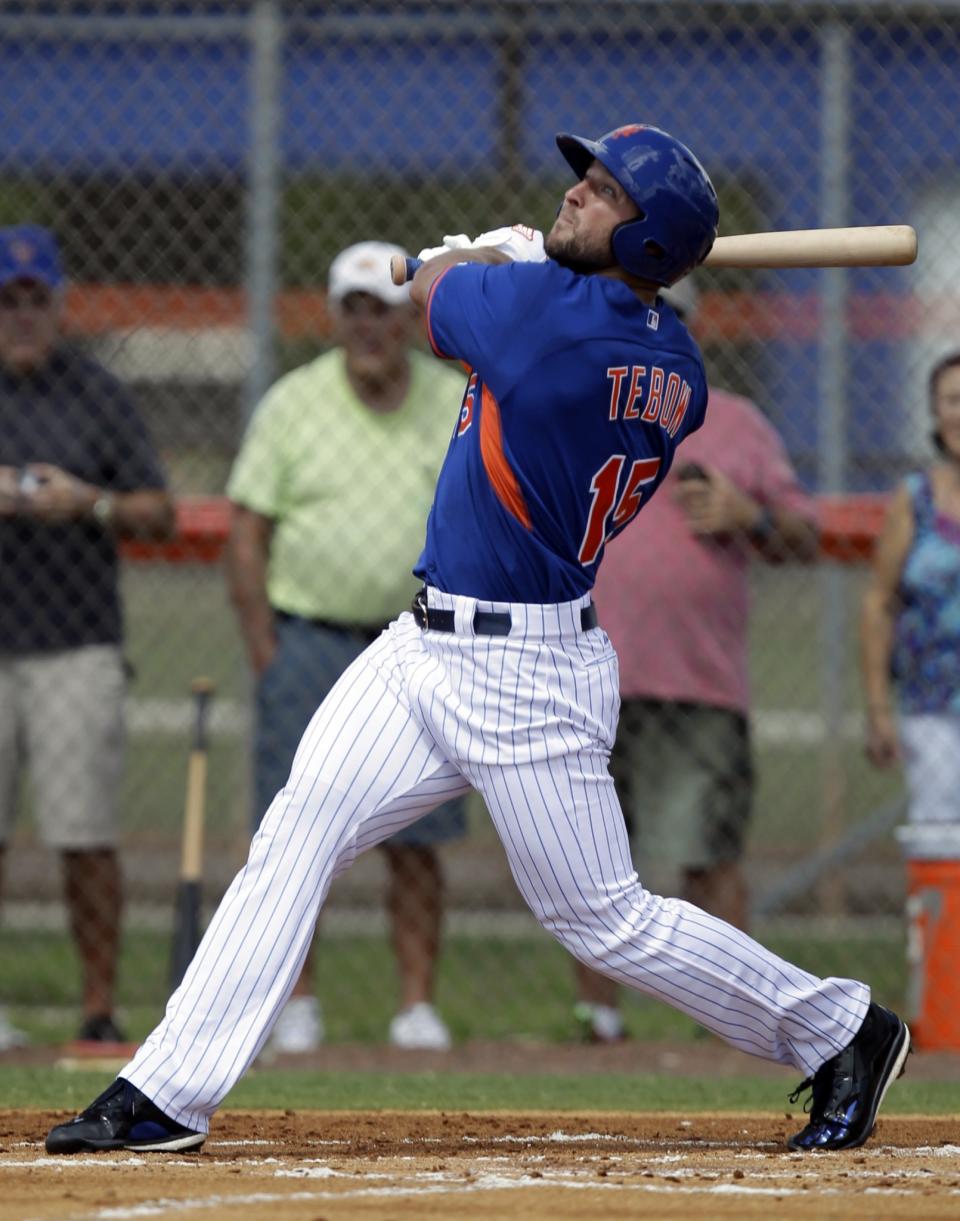 <p>Tim Tebow hits a solo home run in his first at bat during the first inning of his first instructional league baseball game for the New York Mets against the St. Louis Cardinals instructional club Wednesday, Sept. 28, 2016, in Port St. Lucie, Fla. (AP Photo/Luis M. Alvarez) </p>