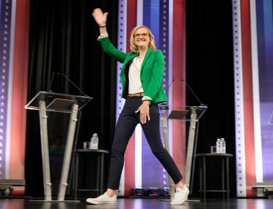 State Treasurer Sarah Godlewski enters the stage during the Democratic U.S. Senate debate at Marquette University's Varsity Theatre in Milwaukee on Sunday, July 17.