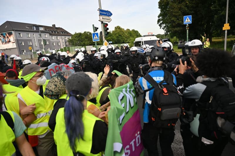 Protesters confront police on an access road to the grounds of the Alternative for Germany (AfD) party conference. Protesters had their first clash with police on Saturday morning, just hours before the AfD party conference was due to start. Henning Kaiser/dpa