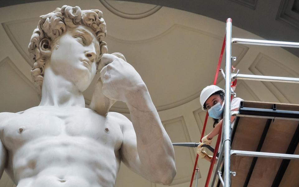 A restorer cleans Michelangelo's David statue while preparing for the reopening of the Galleria dell'Accademia - Laura Lezza/Getty Images