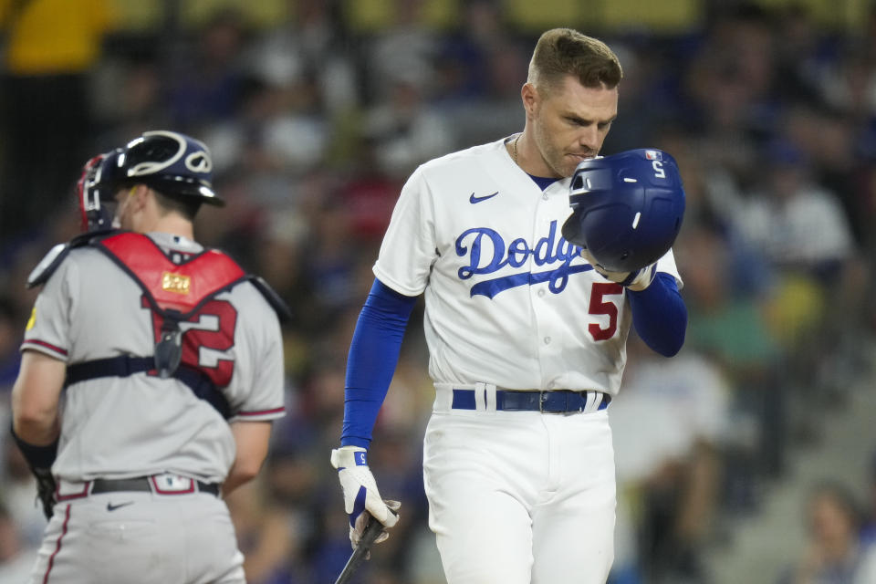 Los Angeles Dodgers' Freddie Freeman takes off his helmet after striking out during the seventh inning of the team's baseball game against the Atlanta Braves on Saturday, Sept. 2, 2023, in Los Angeles. (AP Photo/Jae C. Hong)