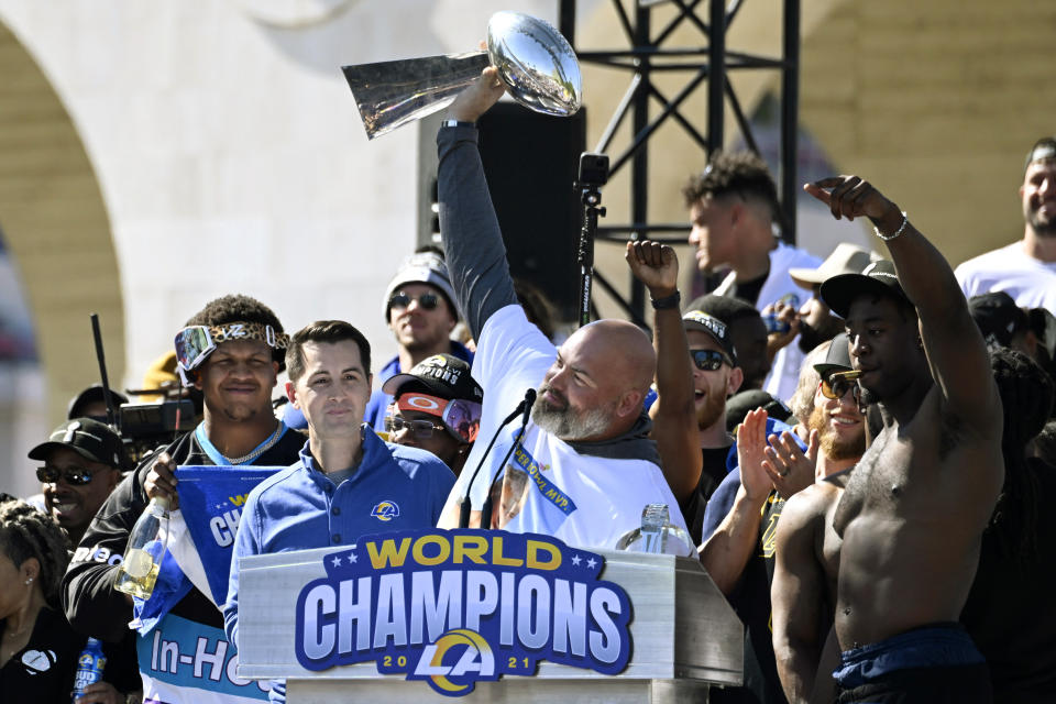 Los Angeles Rams offensive lineman Andrew Whitworth, center, holds up the Vince Lombardi Super Bowl trophy as he celebrates with teammates during the team's victory celebration in Los Angeles, Wednesday, Feb. 16, 2022. The Rams beat the Cincinnati Bengals Sunday in the NFL Super Bowl 56 football game. (AP Photo/Kyusung Gong)