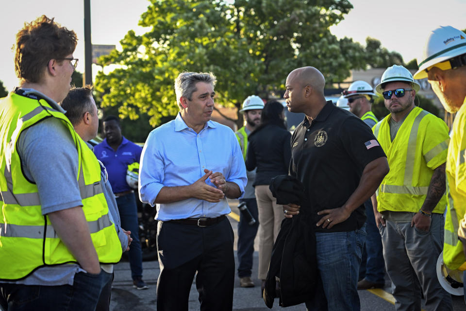 BGE CEO Carim Khouzami, center left, and Maryland Gov. Wes Moore talk prior to a tour of storm damage from Monday evening's storm along Route 140 in Westminster, Md. Tuesday, Aug. 8, 2023. (Jerry Jackson/The Baltimore Sun via AP)