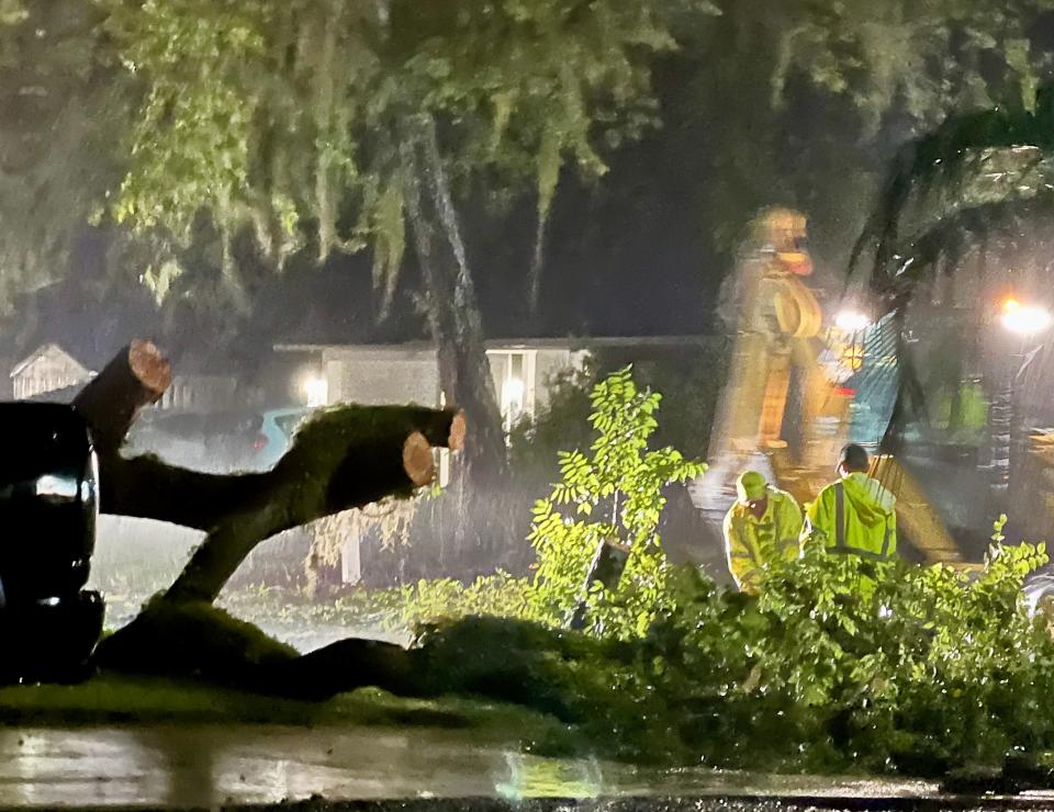 Crews from Holly Hill worked to clean up debris from a fallen tree as wind and rain from Hurricane Ian pounded Volusia County early Thursday, Sept. 29, 2022.