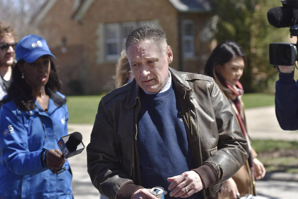 Andrew Freund Sr., the father of the missing 5-year-old Andrew "AJ" Freund, walks near his home on Dole Avenue in Crystal Lake, Ill. on Friday, April 19, 2019 as members of the media try to speak with him. Police are investigating the boy's disappearance and are focusing their attention on the boy's home. (John Starks/Daily Herald via AP)