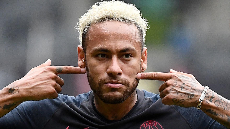 Pictured here, PSG forward Neymar is said to owe Barcelona millions of dollars.