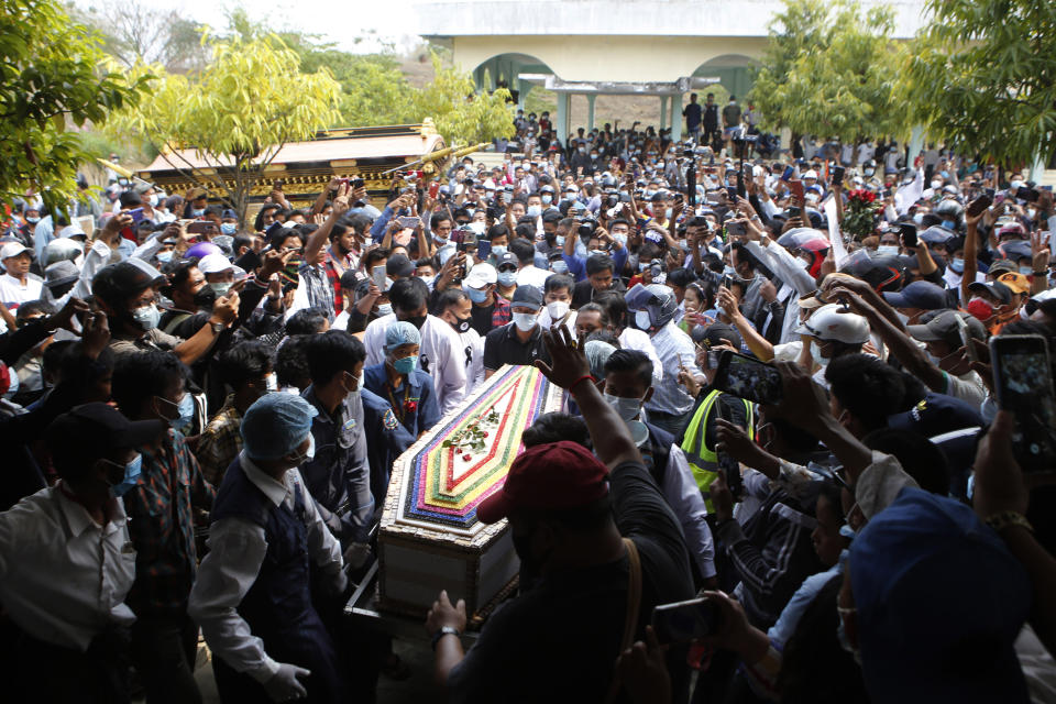 The casket containing the body of Mya Thwet Thwet Khine is carried through the crowds towards the cemetery in Naypyitaw, Myanmar, Sunday, Feb. 21, 2021. Mya Thwet Thwet Khine was the first confirmed death among the many thousands who have taken to the streets to protest the Feb. 1 coup that toppled the elected government of Aung San Suu Kyi. (AP Photo)