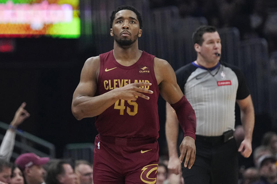 Cleveland Cavaliers guard Donovan Mitchell (45) gestures after a 3-point basket against the Dallas Mavericks during the first half of an NBA basketball game Tuesday, Feb. 27, 2024, in Cleveland. (AP Photo/Sue Ogrocki)