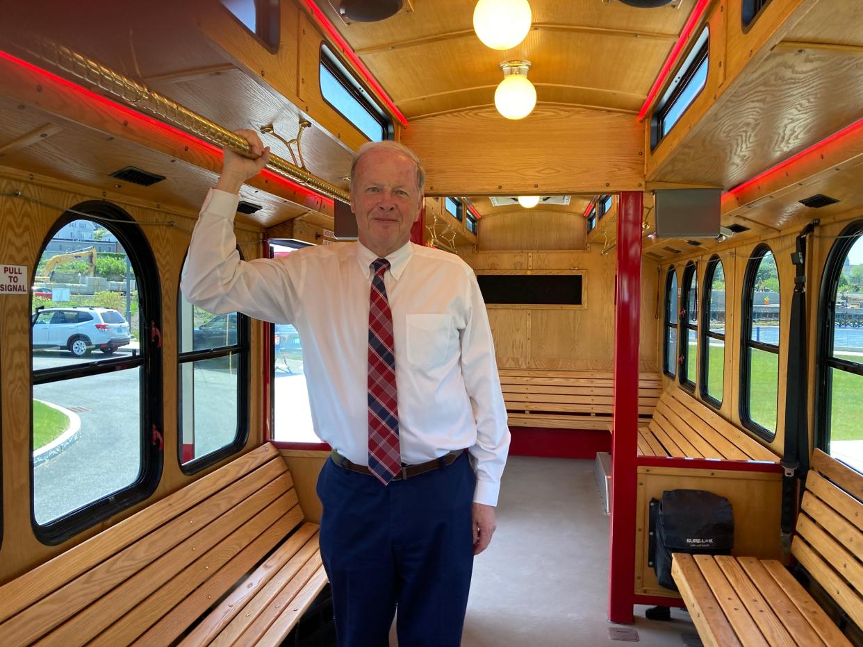 Mayor Paul Coogan shows off the improved interior of the city's new trolley.