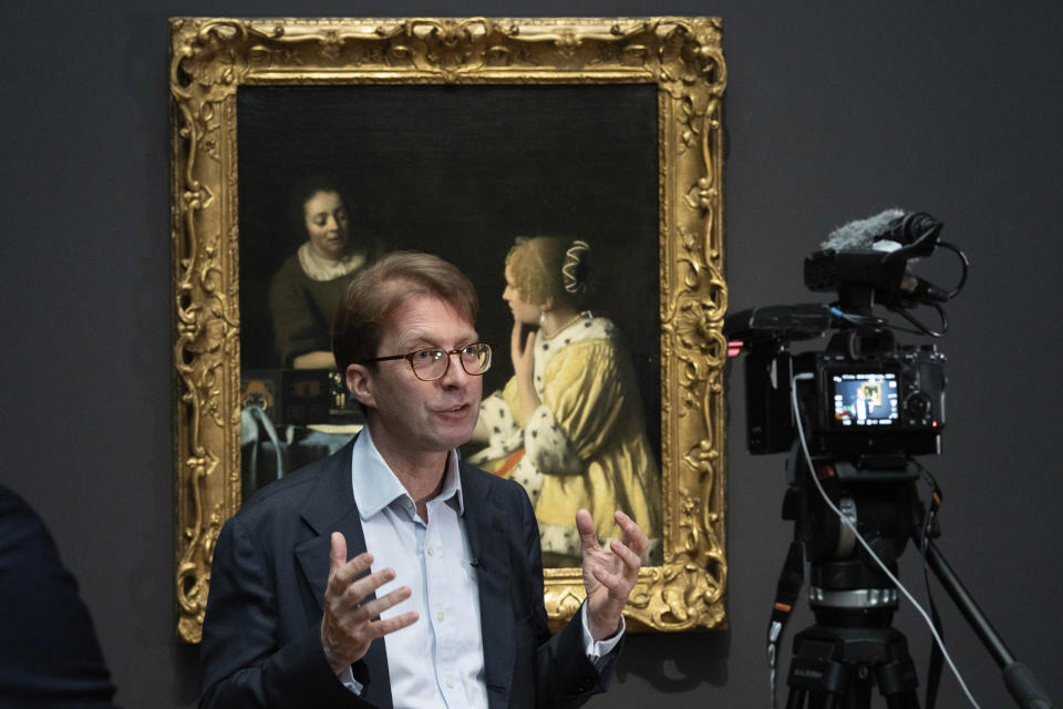 Director Taco Dibbits talks in front of Mistress and Maid, on loan from the Frick Collection, New York, during a press preview of the Vermeer exhibit at Amsterdam's Rijksmuseum, Monday, Feb. 6, 2023, which unveils its blockbuster exhibition of 28 paintings by 17th-century Dutch master Johannes Vermeer drawn from galleries around the world. (AP Photo/Peter Dejong)