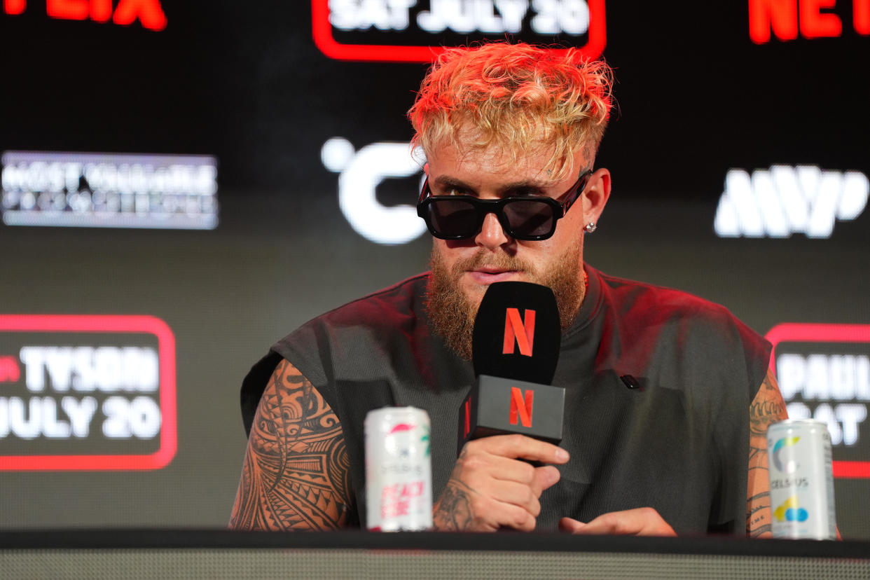 ARLINGTON, TEXAS - MAY 16: Jake Paul speaks onstage during the Jake Paul vs. Mike Tyson Boxing match Arlington press conference at Texas Live! on May 16, 2024 in Arlington, Texas.  (Photo by Cooper Neill/Getty Images for Netflix)