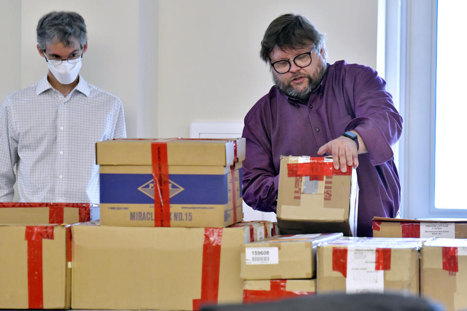 FILE - In this May 11, 2021 file photo, election auditors Mark Lindeman, left, and Harri Hursti catalog ballot boxes in Pembroke, N.H. after they arrived at the site of a forensic audit of a New Hampshire legislative election. Auditors concluded in a report released Tuesday, July 13, 2021, that miscounts in a New Hampshire election were caused by the way ballots were folded. (AP Photo/Josh Reynolds, File)