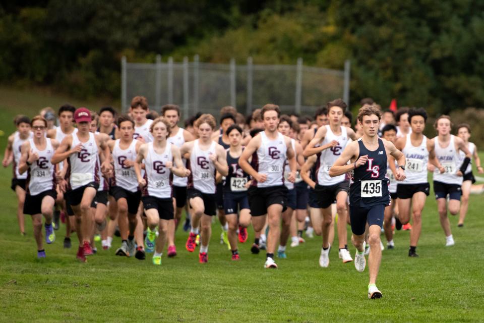 Lincoln-Sudbury junior Ethan Sholk (435) leads the pack at the start of the boys cross country meet in Sudbury against Boston-Latin and Concord-Carlisle, Oct. 11, 2023. Sholk would go on to break the course record with his run.