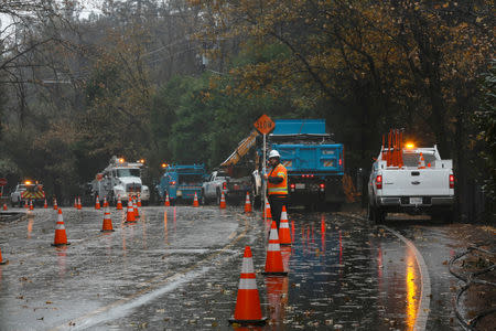 FILE PHOTO: PG&E crew work to repair damage caused by the Camp Fire in Paradise, California, U.S. November 21, 2018. REUTERS/Elijah Nouvelage/File Photo