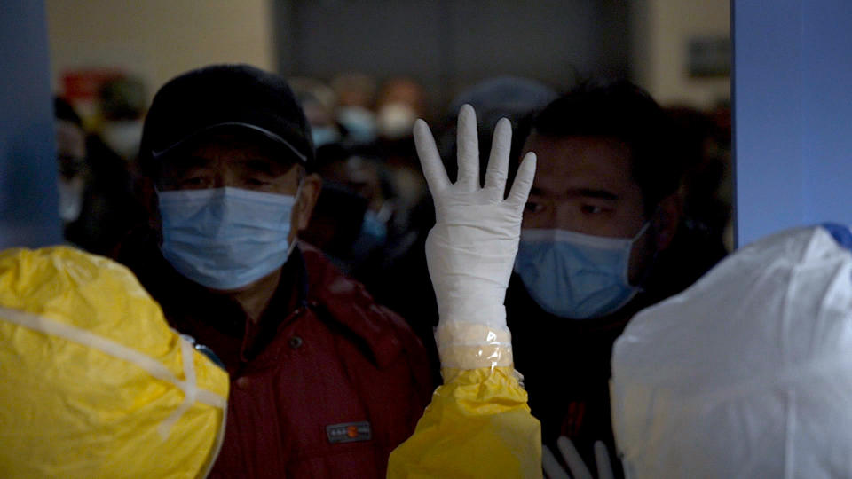 Medical workers limiting the number of patients admitted into a hospital during the peak  of the COVID-19 outbreak in Wuhan, China. As seen in 76 Days, directed by Hao Wu, Weixi Chen and Anonymous. Image courtesy of 76 Days LLC.