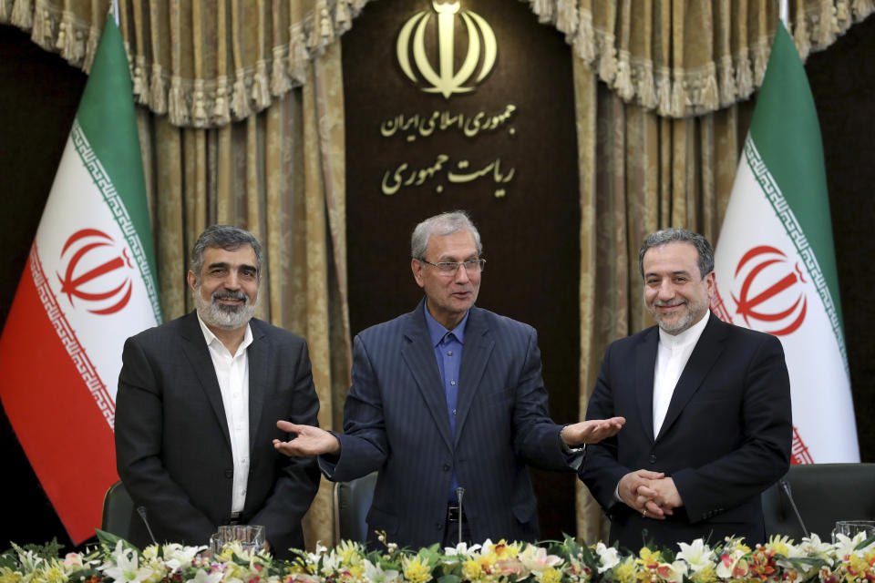 From left to right, spokesman for Iran's atomic agency Behrouz Kamalvandi, Iran's government spokesman Ali Rabiei and Iranian Deputy Foreign Minister Abbas Araghchi, attend a press briefing in Tehran, Iran, Sunday, July 7, 2019. The deputy foreign minister says that his nation considers the 2015 nuclear deal with world powers to be a "valid document" and seeks its continuation. (AP Photo/Ebrahim Noroozi)