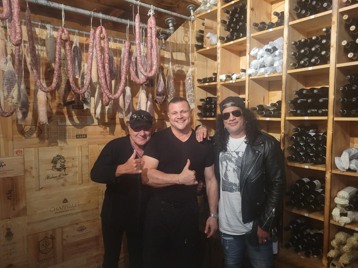 AC/DC singer and Sarasota resident Brian Johnson, left, and Guns N' Roses guitarist Slash, right, had dinner at Sarasota restaurant Marcello Ristorante, owned by Marcello Aquino, center. The dinner happened as Johnson was recording his vocals for a cover of Howlin' Wolf's "Killing Floor" off Slash's upcoming album, with Slash visiting Sarasota to attend the session.