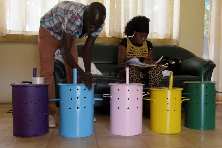 Gambian polling agent prepare voting barrels at a polling station in Banjul on April 5, 2017, a day ahead of legislative elections