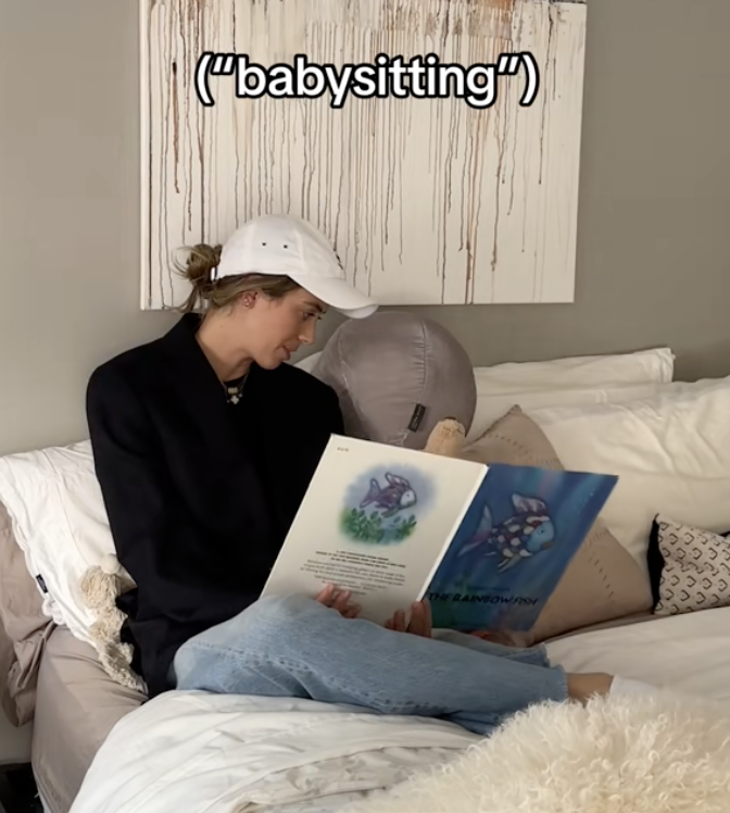 Dad reading a child a book in bed with caption "babysitting"