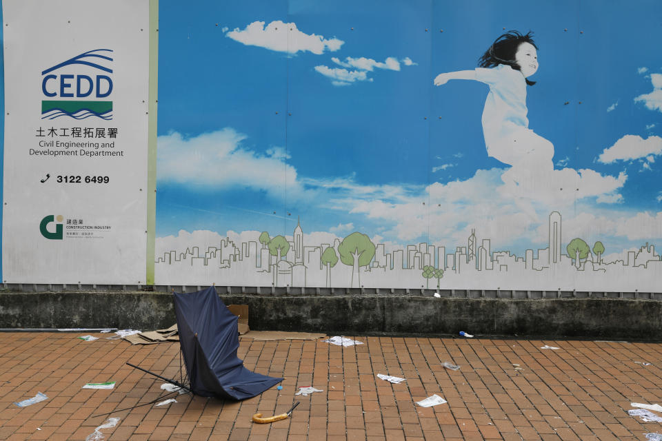 In this Friday, June 14, 2019, photo, a broken umbrella left in the aftermath of Wednesday's violent protest against proposed amendments to an extradition law is seen in Hong Kong. Umbrellas became a symbol of protest in Hong Kong in 2014 after demonstrators used them to shield themselves from both police pepper spray and a hot sun. Five years later, umbrellas were out in force again on Wednesday as thousands of protesters faced off with police outside the legislature. (AP Photo/Vincent Yu)