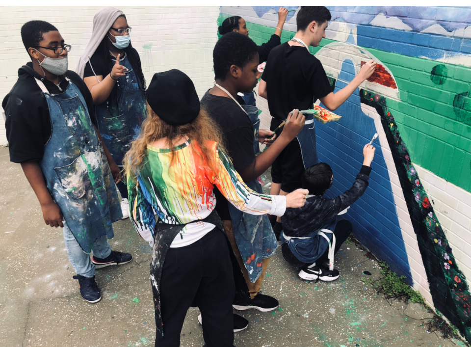 Lake Weir Middle School art students work on a mural project on campus.