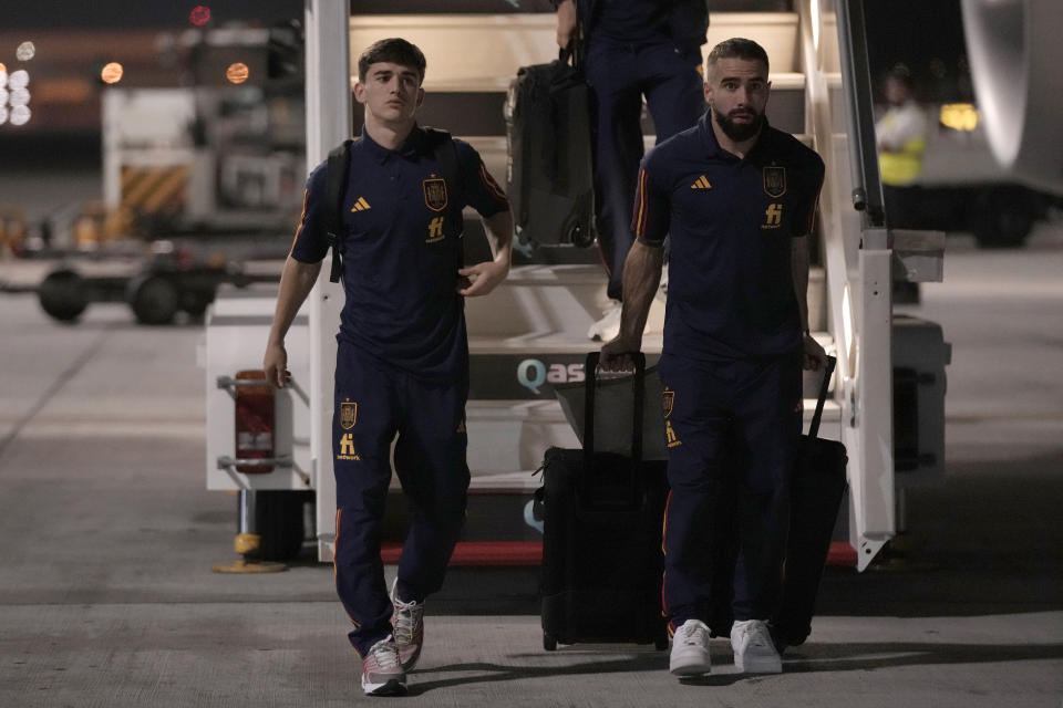 Gavi, left, and Dani Carvajal of Spain's national soccer team arrive with teammates at Hamad International airport in Doha, Qatar, Friday, Nov. 18, 2022 ahead of the upcoming World Cup. Spain will play the first match in the World Cup against Costa Rica on Nov. 23. (AP Photo/Hassan Ammar)
