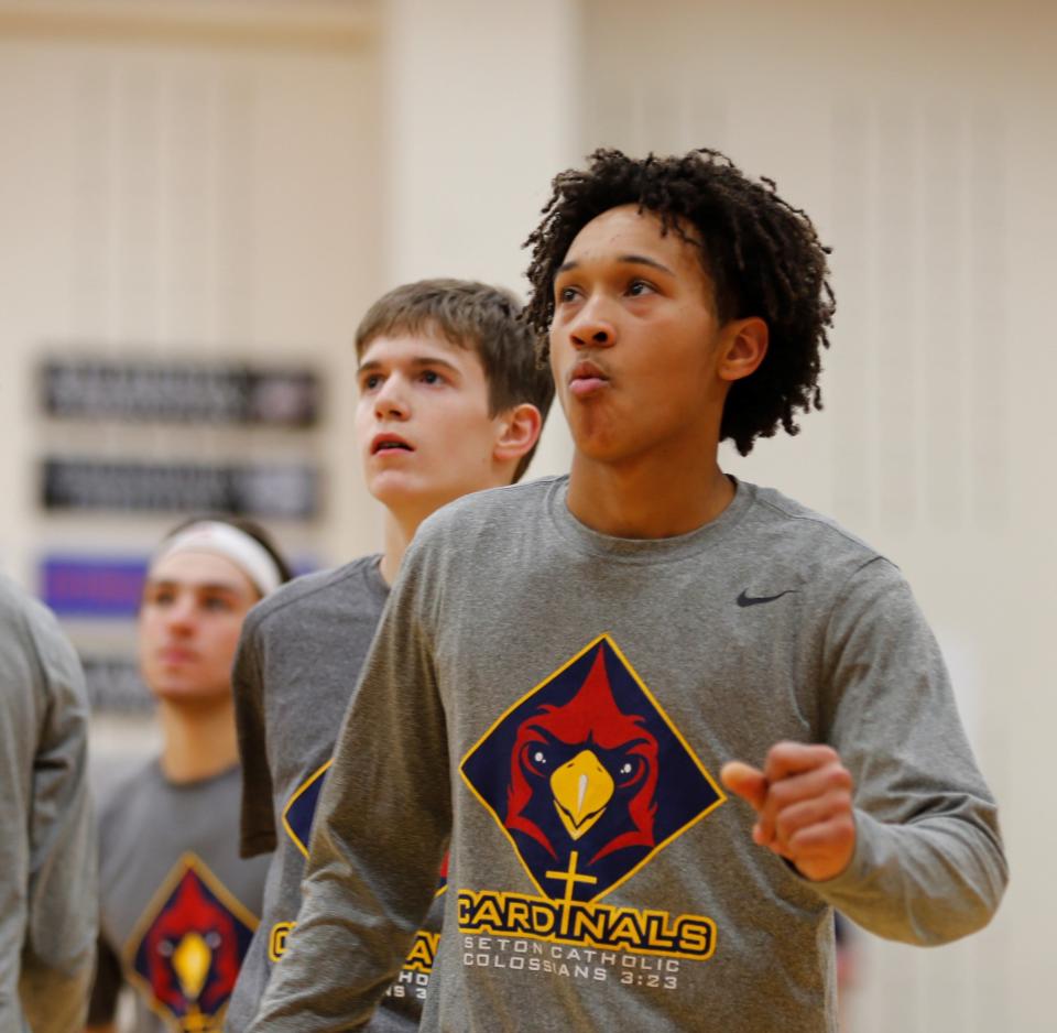 Seton senior Tristian Washington (right) and sophomore Andrew Warner (left) watch their teammates shoot during warmups before a game against Blue River Valley Jan. 25, 2022.