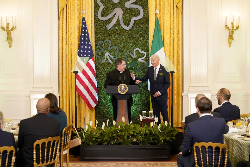 Cardinal Christophe Pierre, apostolic nuncio to the United States, left, and President Joe Biden speak at a St. Patrick's Day brunch with Catholic leaders in the East Room of the White House, Sunday, March 17, 2024. (AP Photo/Stephanie Scarbrough)