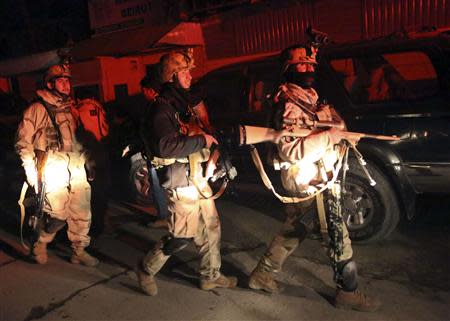 Afghan security forces arrive at the scene of an explosion in Kabul January 17, 2014. At least 13 people, including both Afghans and foreigners, were killed when a suicide bomber blew himself up near a popular Lebanese restaurant in the Afghan capital Kabul on Friday, police said. REUTERS/Omar Sobhani