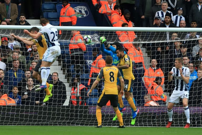 West Bromwich Albion's Craig Dawson (left) heads to score during the Premier League match against Arsenal at The Hawthorns stadium in central England, on March 18, 2017